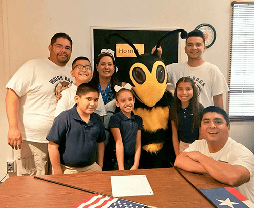 Dad supporting kids during school day