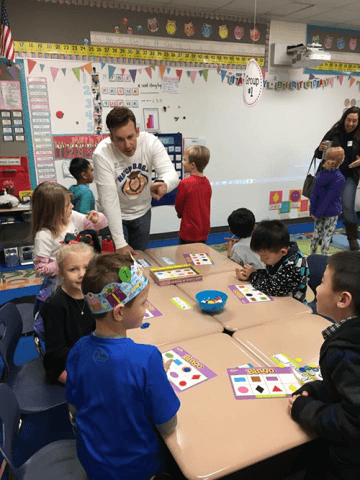 Dad reading with a small group of students