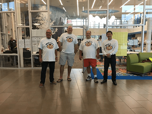 Father figure greeting students at entrance